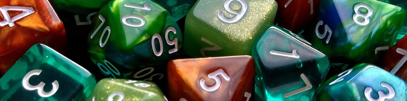 A very close photo of green, teal, blue, and burnt orange polyhedreal dice